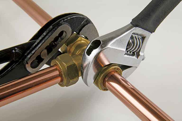 Wrenches on plumbing fittings